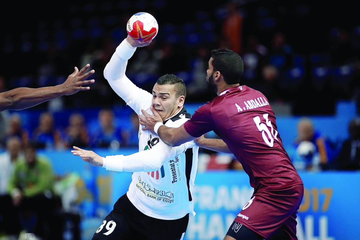 Abdelrahman Abdalla of Qatar and Mohamed Mamdouh Shebib of Egypt vie for ball possession during the 2017 Men's World Championship match of Group D at AccorHotels Arena, Paris, France, yesterday. 