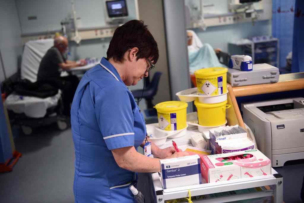 (FILES) This file photo taken on April 2, 2015 shows a member of clinical staff recording details of blood samples in the Accident and Emergency department of the 'Royal Albert Edward Infirmary' in Wigan, north west England. The Red Cross describes a 