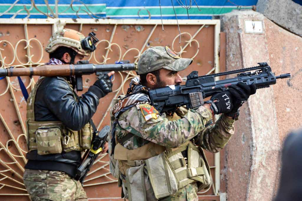 Iraqi forces take aim in Mosul's southern Sumer neighbourhood on January 13, 2017, during an ongoing military operation against the militants. / AFP / Mahmoud AL-SAMARRAI