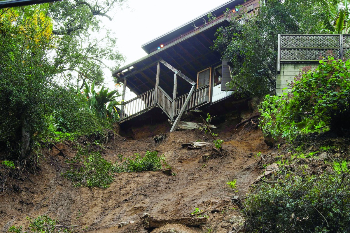 A home sits on the edge of a cliff yesterday after it's concrete portion was washed away in a mudslide caused by heavy rains in Hollywood, California.