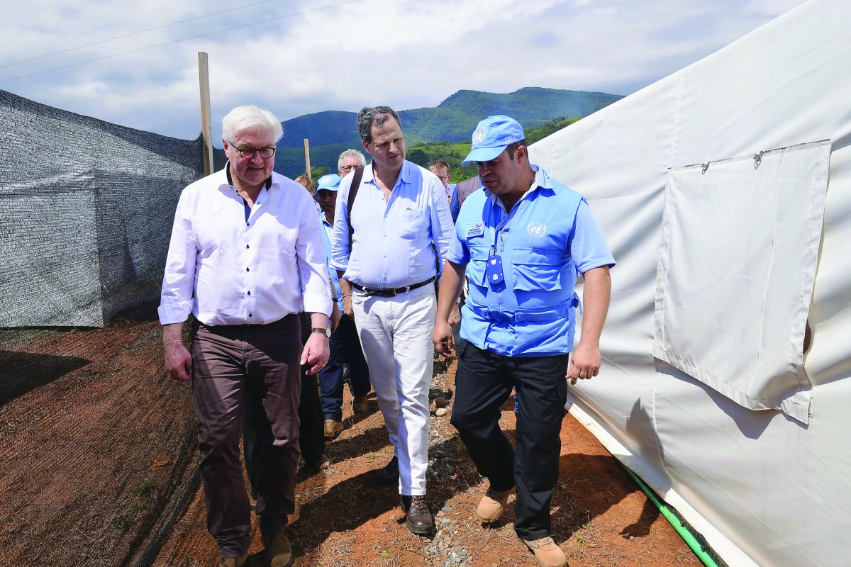 Handout picture released by Colombia's High Commissioner for Peace's press office showing German Foreign Minister Frank-Walter Steinmeier (L) walking next to Colombian High Commissioner for Peace, Sergio Jaramillo (C) and a UN representative, member of th