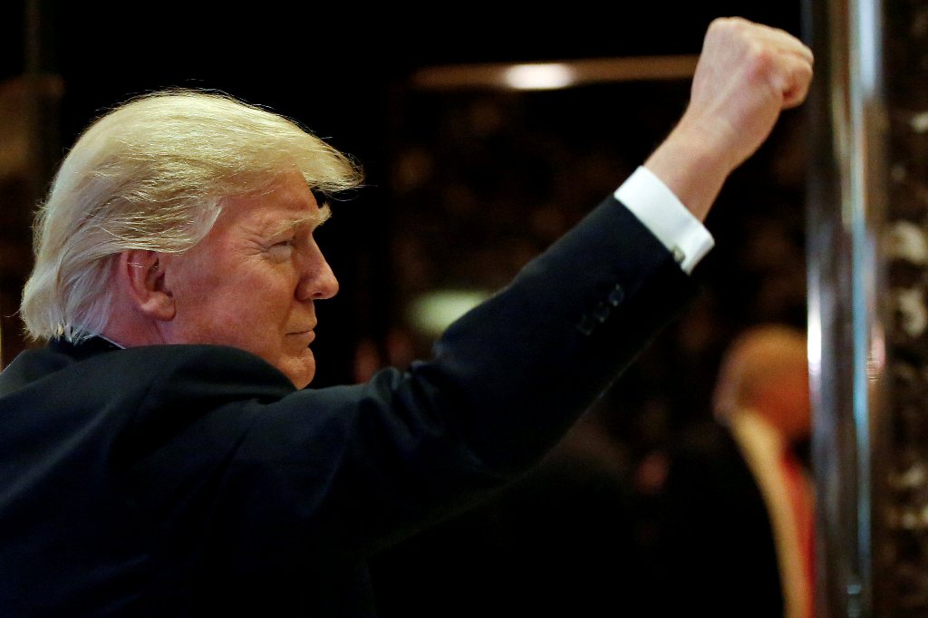 FILE PHOTO: U.S.President-elect Donald Trump gestures to people in the lobby after speaking to the news media at Trump Tower in New York, U.S., January 13, 2017. REUTERS/Shannon Stapleton/File photo
