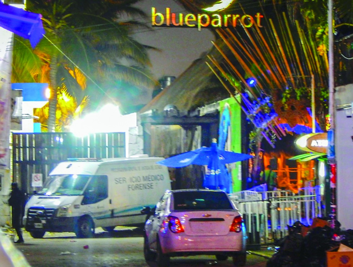 A Forensic Medical Service van is parked outside a club near the beach in Playa del Carmen, where five people were killed, during a music festival yesterday.