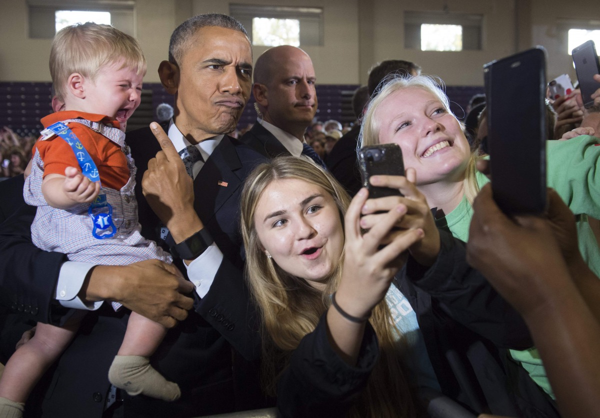 US President Barack Obama holds 10-month-old Brooks Breitwieser as he greets supporters after speaking to a 