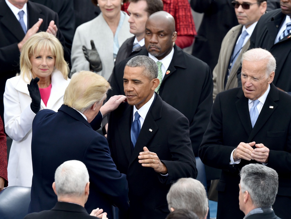 President-elect Donald Trump(L) is greeted by US President Barack Obama as he arrives on the platform at the US Capitol in Washington, DC, on January 20, 2017, before his swearing-in ceremony to be the 45th president of the US. / AFP / Paul J. Richards