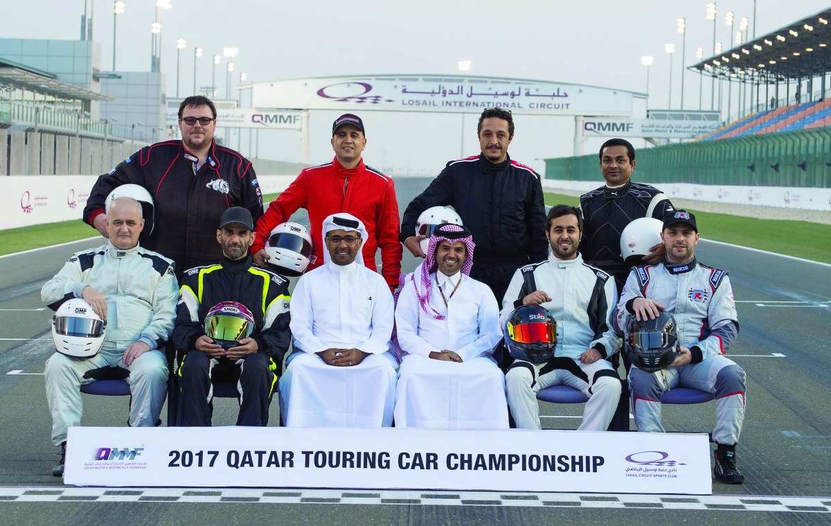 QMMF President, Abdulrahman Al Mannai and LCSC Vice President and General Manager, Khalid Al Remaihi pose for a photograph with riders after the practice session of the opening round of the Qatar Touring Car Championship (QTCC) yesterday.