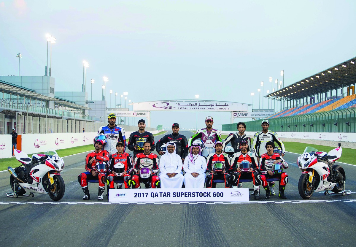 QMMF President, Abdulrahman Al Mannai and LCSC Vice President and General Manager, Khalid Al Remaihi pose for a photograph with riders after the free practice sessions of opening round of the Qatar Superstock 600 (QSTK) at Losail International Circuit yes
