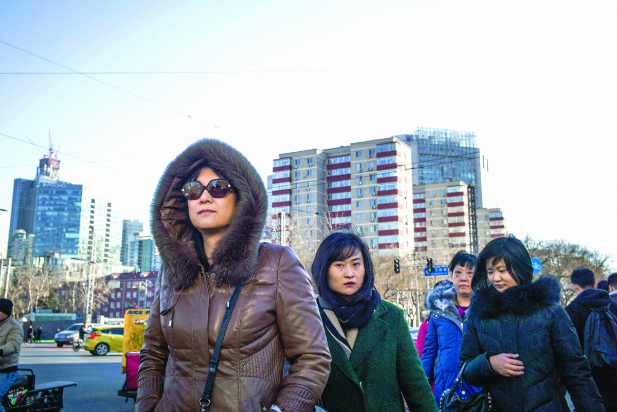 People walking in the street on their way to work in Beijing.