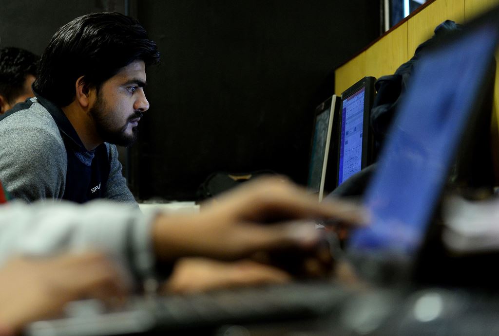 In this photograph taken on December 13, 2016, an employee of Indian IT security solutions company Innefu Labs works at their offices in New Delhi. AFP / SAJJAD HUSSAIN 
