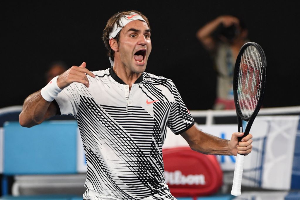 Switzerland's Roger Federer celebrates his victory against Japan's Kei Nishikori during their men's singles fourth round match on day seven of the Australian Open tennis tournament in Melbourne on January 22, 2017. AFP / SAEED KHAN 
