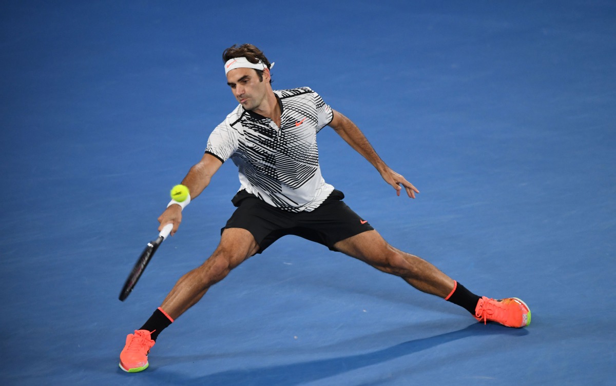 Switzerland's Roger Federer hits a return against compatriot Stanislas Wawrinka during their men's singles semi-final match on day 11 of the Australian Open tennis tournament in Melbourne on January 26, 2017. (AFP / SAEED KHAN)
