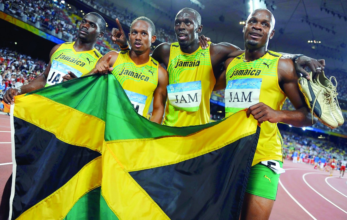Asafa Powell, Usain Bolt, Michael Frater, Nesta Carter of Jamaica celebrate after winning the gold medal for  Men's 4x100m relay at the National Stadium during the Beijing 2008 Olympic Games in this August 22, 2008 file photo.  Usain Bolt has lost one of 