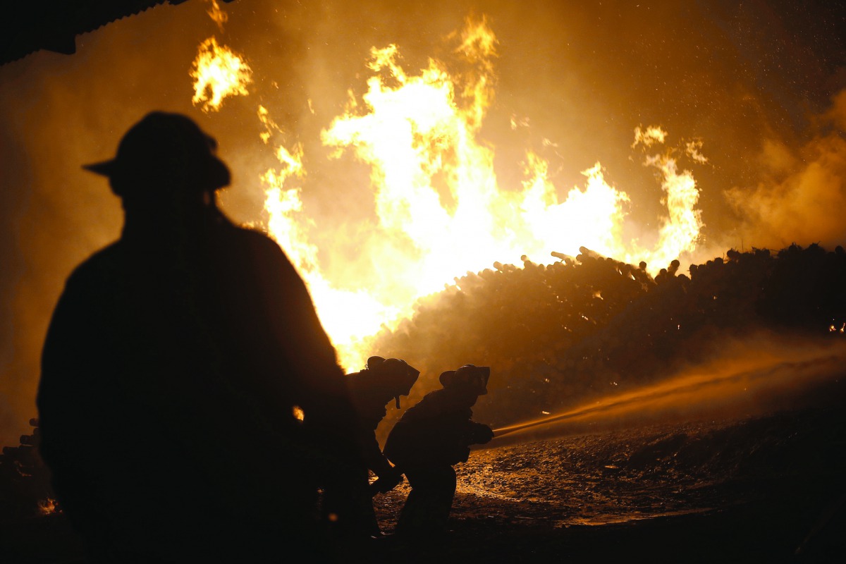 Firefighters work to extinguish blaze inside Mallorca Forest Company in San Ramon, 240km south of Santiago, yesterday.