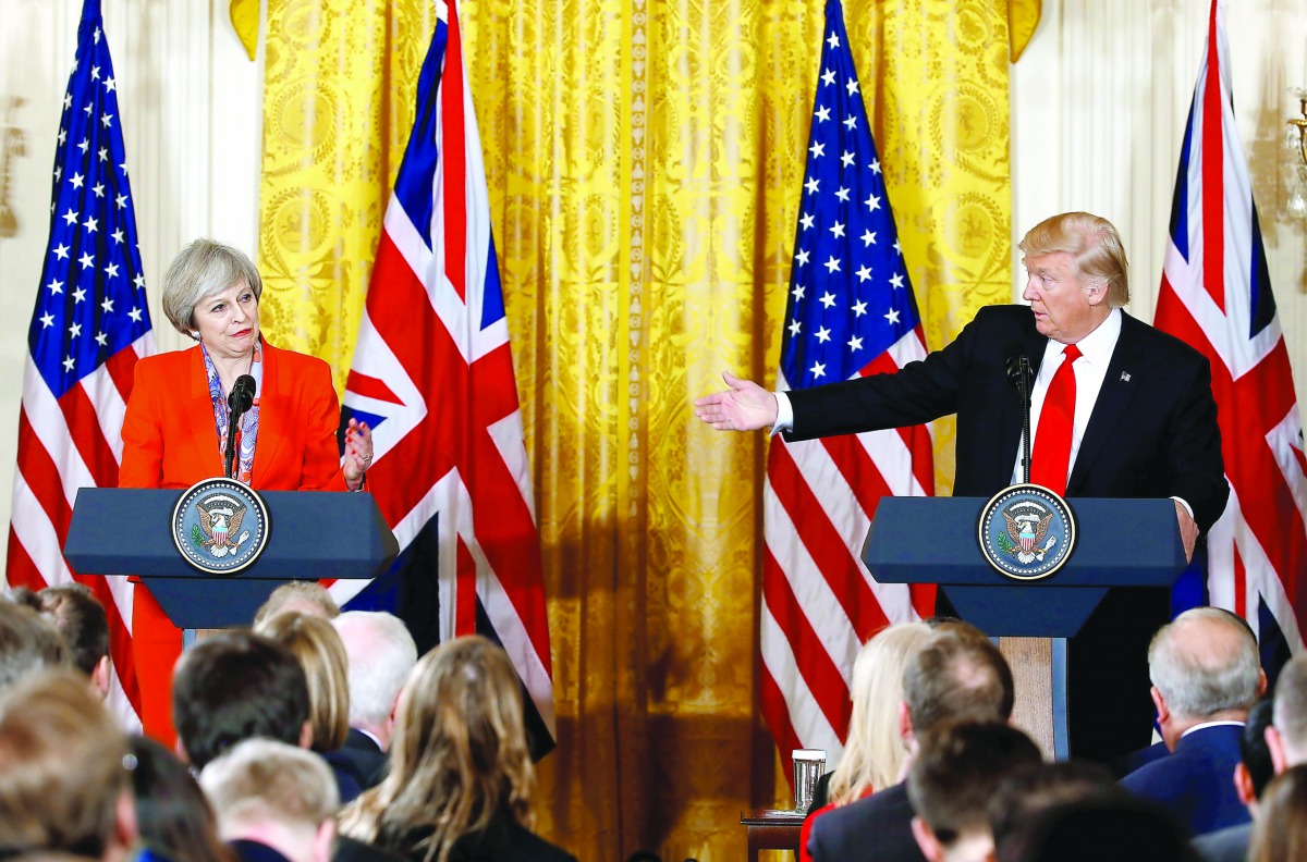 British Prime Minister Theresa May and US President Donald Trump speak during their joint news conference at the White House in Washington, yesterday.