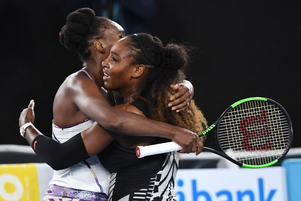 Serena Williams of the US (R) hugs Venus Williams of the US after winning the women's singles final on day 13 of the Australian Open tennis tournament in Melbourne on January 28, 2017. AFP / WILLIAM WEST