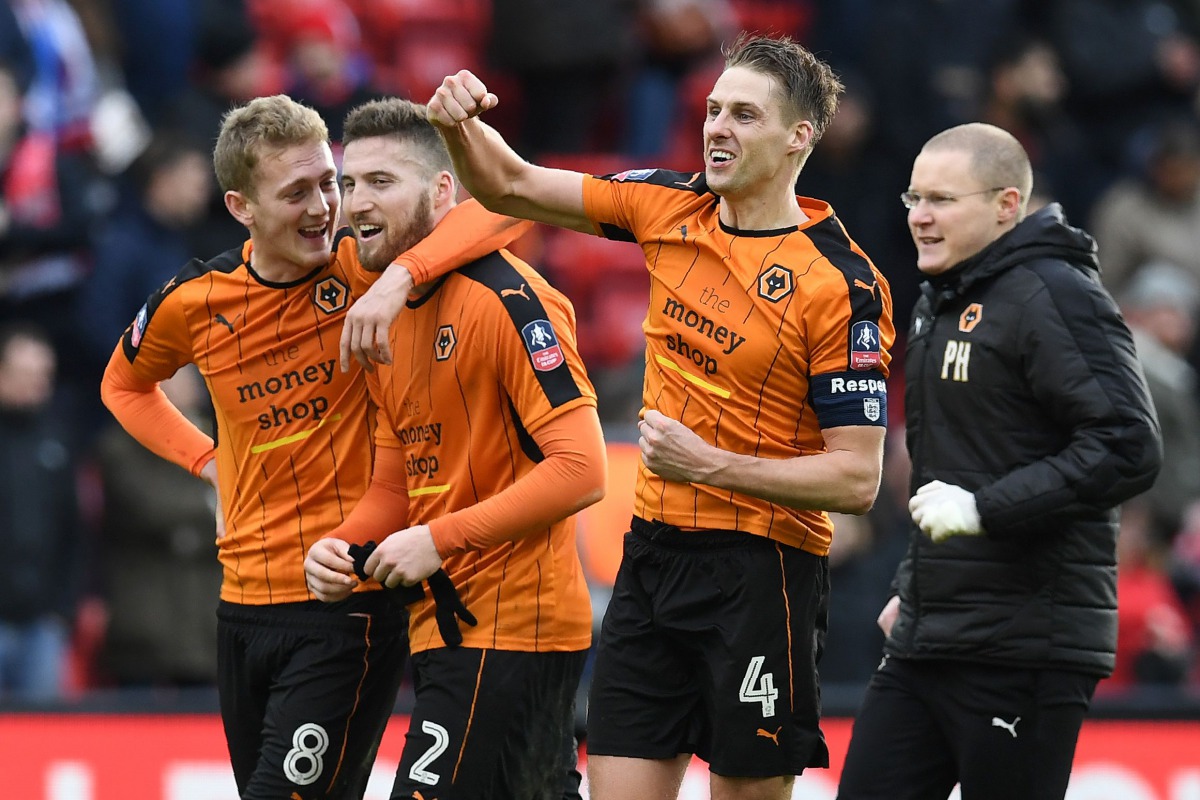 Wolverhampton Wanderers' Welsh midfielder David Edwards (2R) celebrates following the English FA Cup fourth round football match between Liverpool and Wolverhampton Wanderers at Anfield in Liverpool, north west England on January 28, 2017. Wolverhampton w