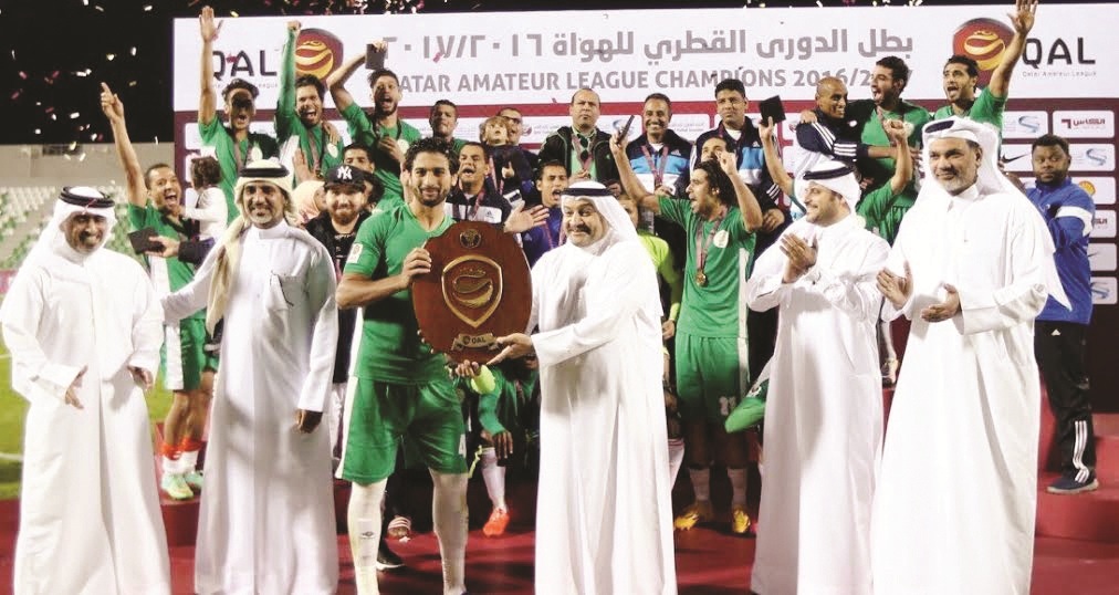Hani Balan, Executive Committee Member of the QFA giving away the trophy to Al Waab captain at Al Ahli Stadium on Friday. Fahad Thani, Director of Football Development QFA, Ibrahim Shaheen, Chairman of the QAL Organising Committee, and Sami Al Shammari, E