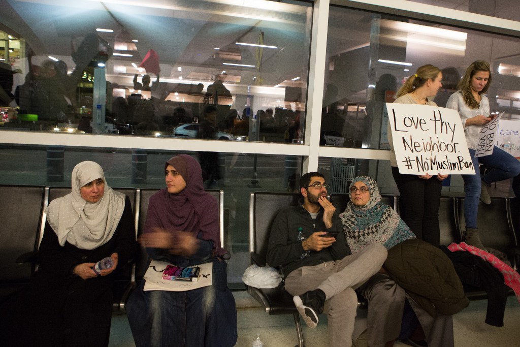 Protesters gather to denounce President Donald Trump's executive order that bans certain immigration, at Dallas-Fort Worth International Airport on January 28, 2017 in Dallas, Texas. President Trump signed the controversial executive order that halted ref