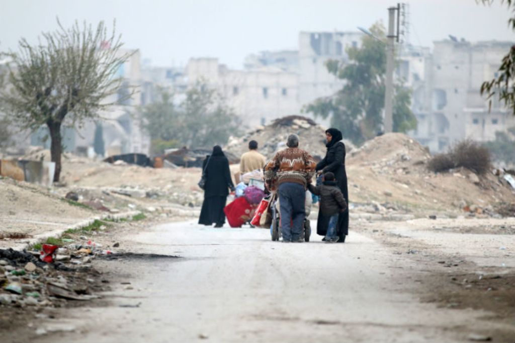 People carry their belongings as they flee the Kadi Askar area towards Bustan al-Qasr neighbourhood, in rebel-held besieged Kadi Askar area of Aleppo, Syria December 5, 2016. REUTERS/Abdalrhman Ismail
