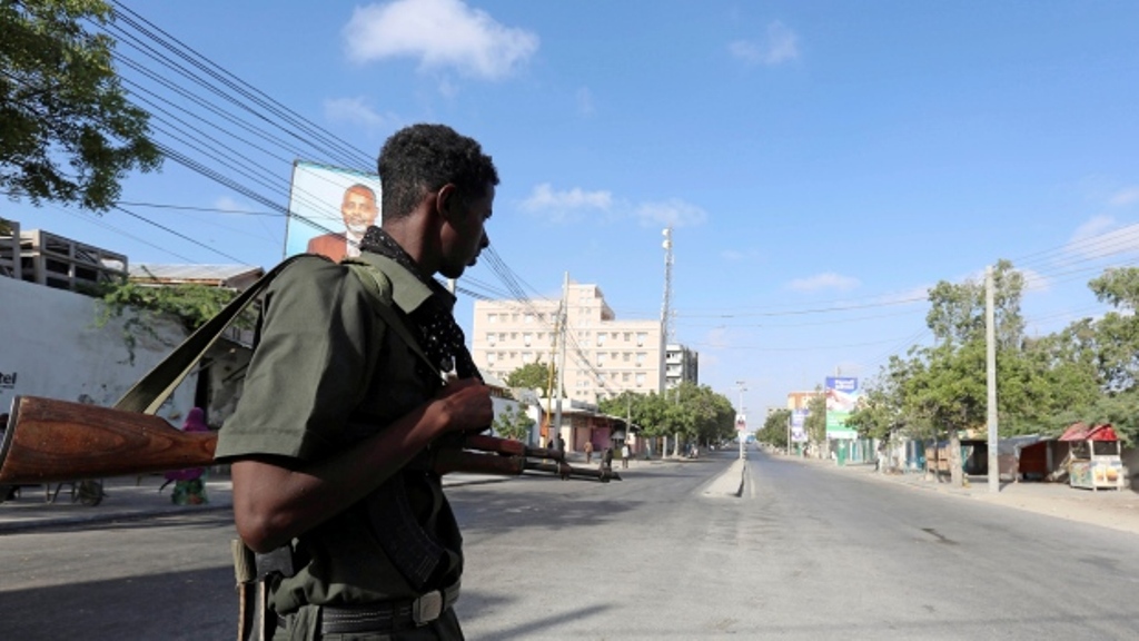 A policeman stands guard along a road that was blocked amid a security lockdown in the capital, Mogadishu, on February 7. Four hotel guards were killed by al-Shabaab militants in the port city of Bosasso. (Feisal Omar/Reuters).
