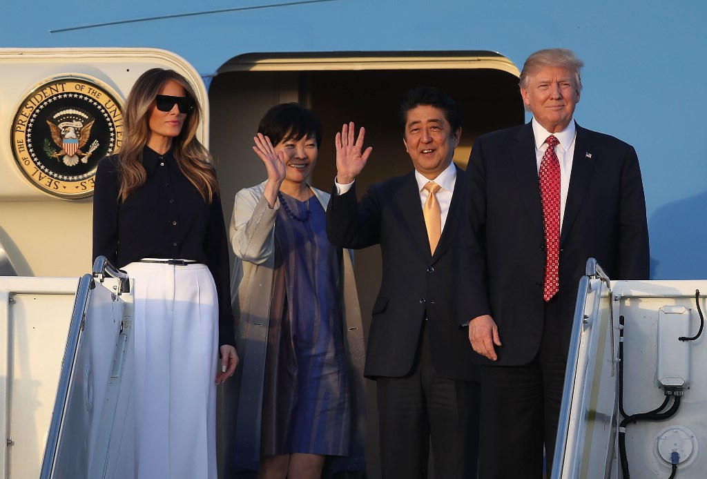 President Donald Trump and his wife Melania Trump arrive with Japanese Prime Minister Shinzo Abe and his wife Akie Abe on Air Force One at the Palm Beach International airport as they prepare to spend part of the weekend together at Mar-a-Lago resort on F