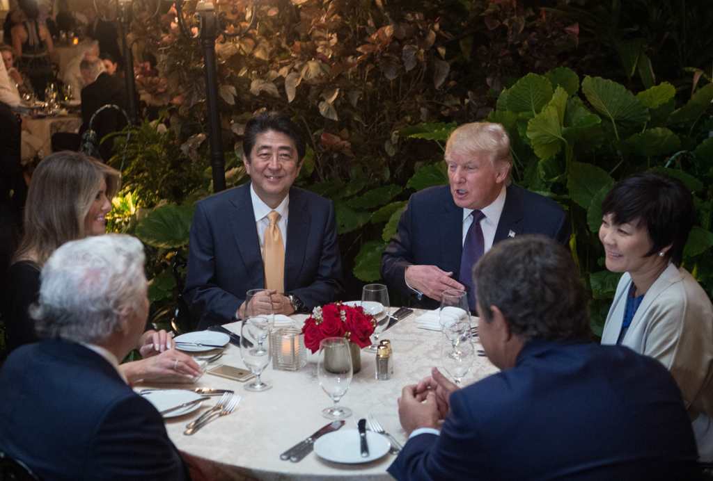 US President Donald Trump, Japanese Prime Minister Shinzo Abe (2nd-L), his wife Akie Abe (R), US First Lady Melania Trump (L) and Robert Kraft (2nd-L),owner of the New England Patriots, sit down for dinner at Trump's Mar-a-Lago resort on February 10, 2017
