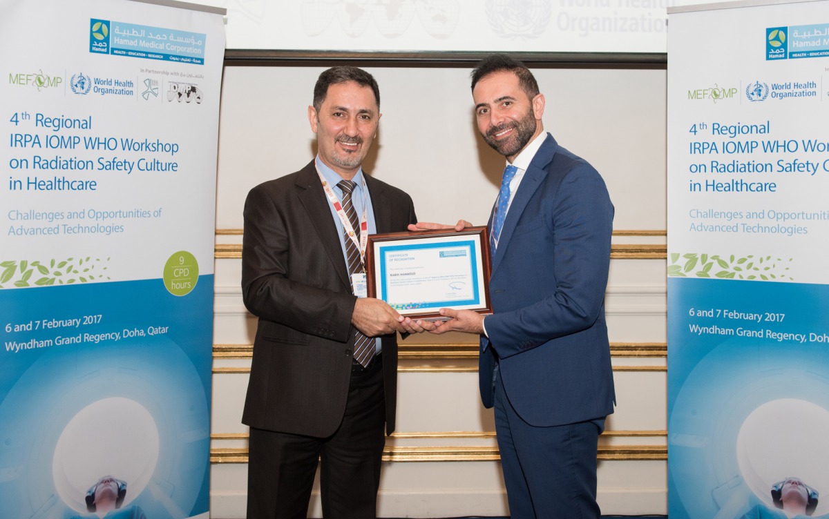 Dr Mohammed Hassan Kharita presents a certificate to  Rabih Wafiq Hammoud of HMC’s OHS Department.