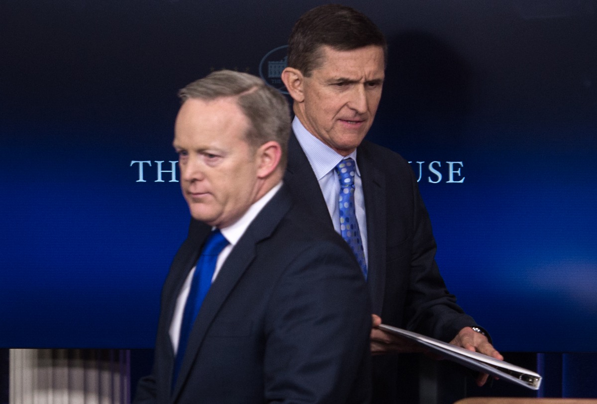 This file photo taken on February 01, 2017 shows US National Security Adviser Mike Flynn (R) walking past Press Secretary Sean Spicer as he makes his way to the lectern during the daily press briefing at the White House in Washington, DC. (AFP / NICHOLAS 