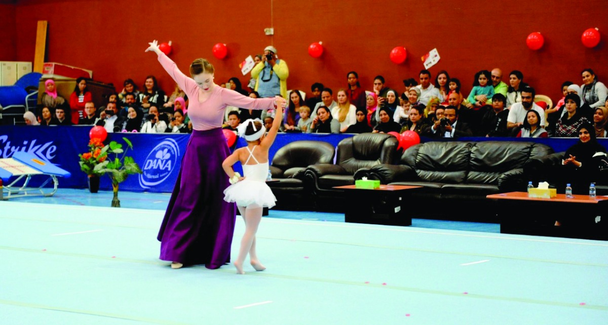 Young gymnasts perform during a ceremony hosted by Qatar Gymnastics Federation (QGF) to celebrate the National Sport Day at the Khawla Gymnastics Hall yesterday. TOP RIGHT: Participants pose for a photograph with QGF officials during the event. QGF staff,