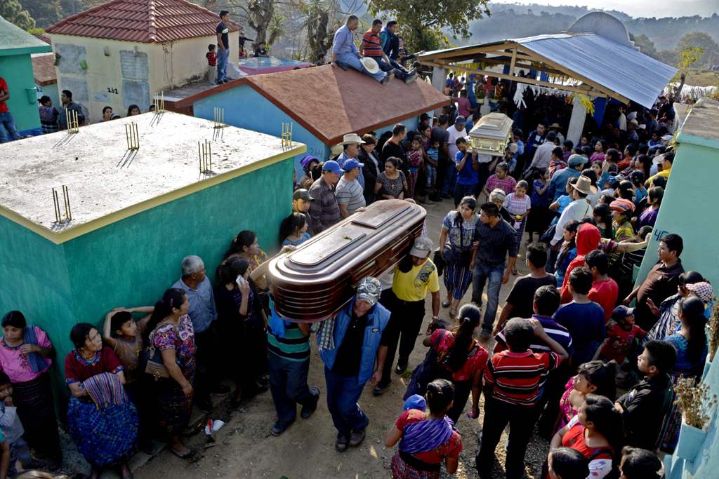 Thousands of indigenous Guatemalans accompany to the cemetery the coffins of two children killed by their kidnappers in the Cerro Alto village in San Juan Sacatepequez, 45km west of Guatemala city on February 14, 2017. AFP / JOHAN ORDONEZ
