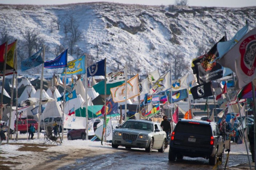 Flags flap in the wind on the main thoroughfare of Oceti Sakowin Camp on the edge of the Standing Rock Sioux Reservation on December 3, 2016 outside Cannon Ball, North Dakota (AFP Photo/JIM WATSON)
