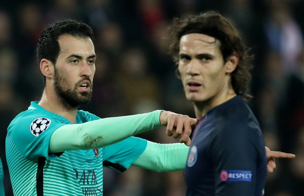 Paris Saint-Germain's Edinson Cavani and Barcelona's Sergio Busquets Reuters / Christian Hartmann 
