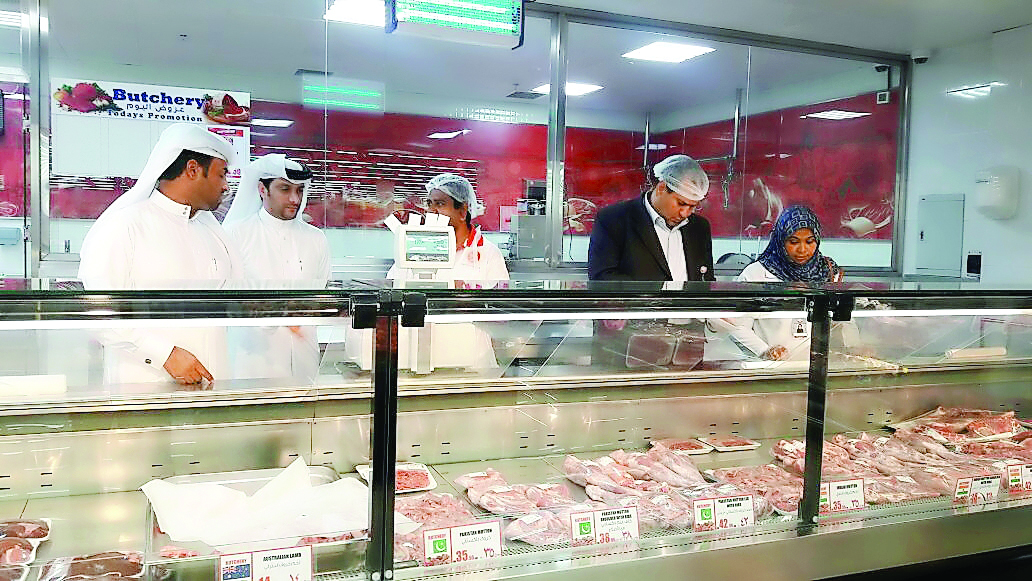 Inspectors checking meat at a butchery. 