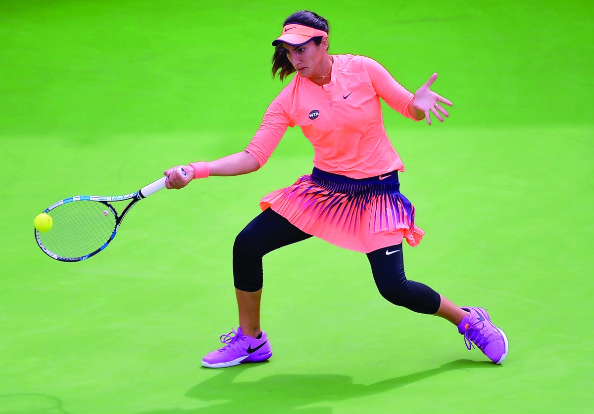 Fatma Al Nabhani of Oman hits a return to Barbora Strycova of Czech Republic during their Qatar Total Open first round at the Khalifa International Tennis Complex in Doha yesterday.  Pic: Anvar C H