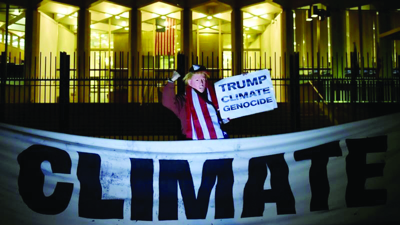 A man wearing a mask depicting US President Donald Trump protests during a demonstration 
