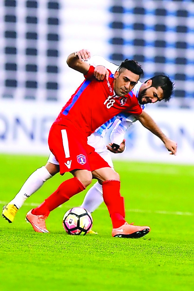 Al Shahaniyah's Rahim Abbas Mehdi (left) vies for the ball possession with an Al Wakrah player during their Qatar Stars League match which ended in a two-all draw at Al Wakrah Stadium yesterday.