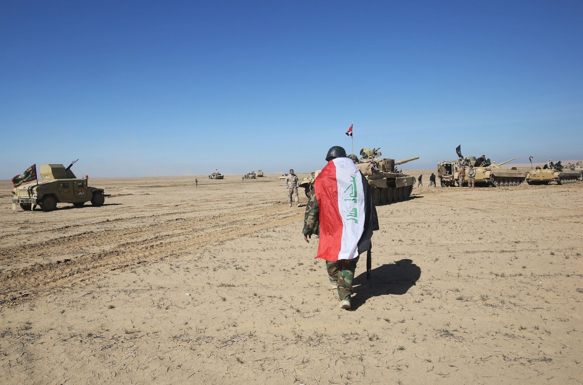 Iraqi forces, supported by the Hashed al-Shaabi (Popular Mobilisation) paramilitaries, prepare to advance advance towards the village of Sheikh Younis, south of Mosul, after the offensive to retake the western side of the city from Islamic State (IS) grou