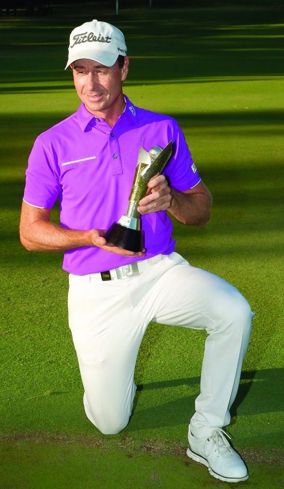 Brett Rumford of Australia poses with the winner's trophy after winning the final of the new World Super 6 golf tournament in Perth yesterday. 