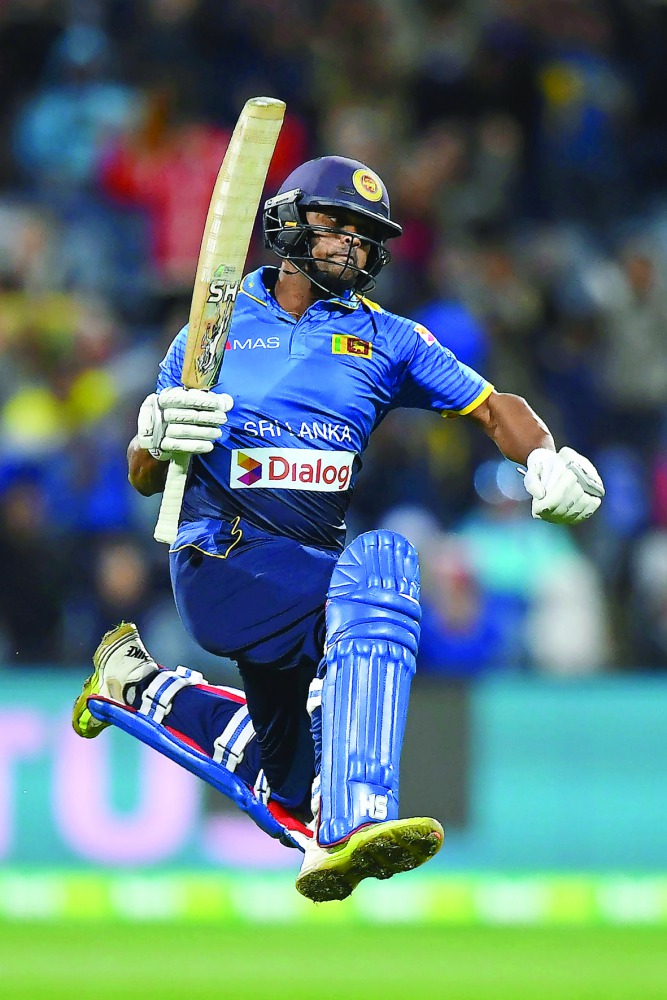 Sri Lankan batsman Asela Gunaratne celebrates after scoring the winning run during the second Twenty20 cricket match against Australia at Kardinia Park in Geelong yesterday.