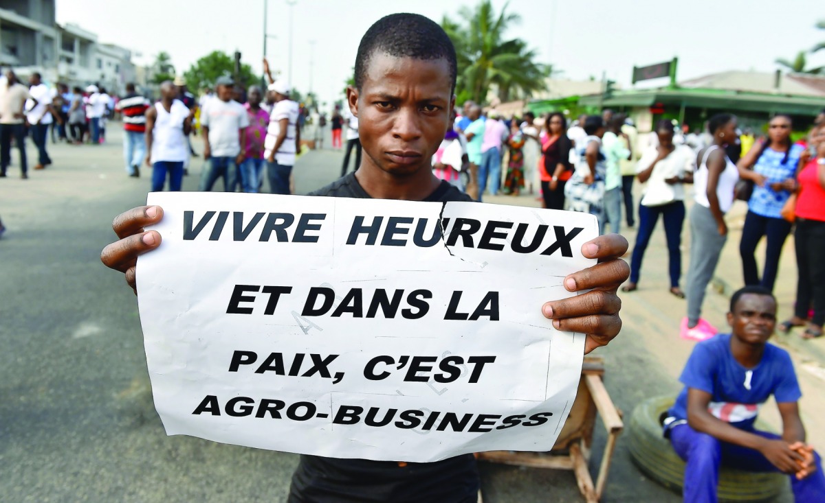 A subscriber who invested in agribusiness companies, takes part in a demonstration in Abidjan, Ivory Coast after justice froze the assets of some 28 companies suspected of a vast swindle. Attracted by juicy profits and investment returns, thousands of peo