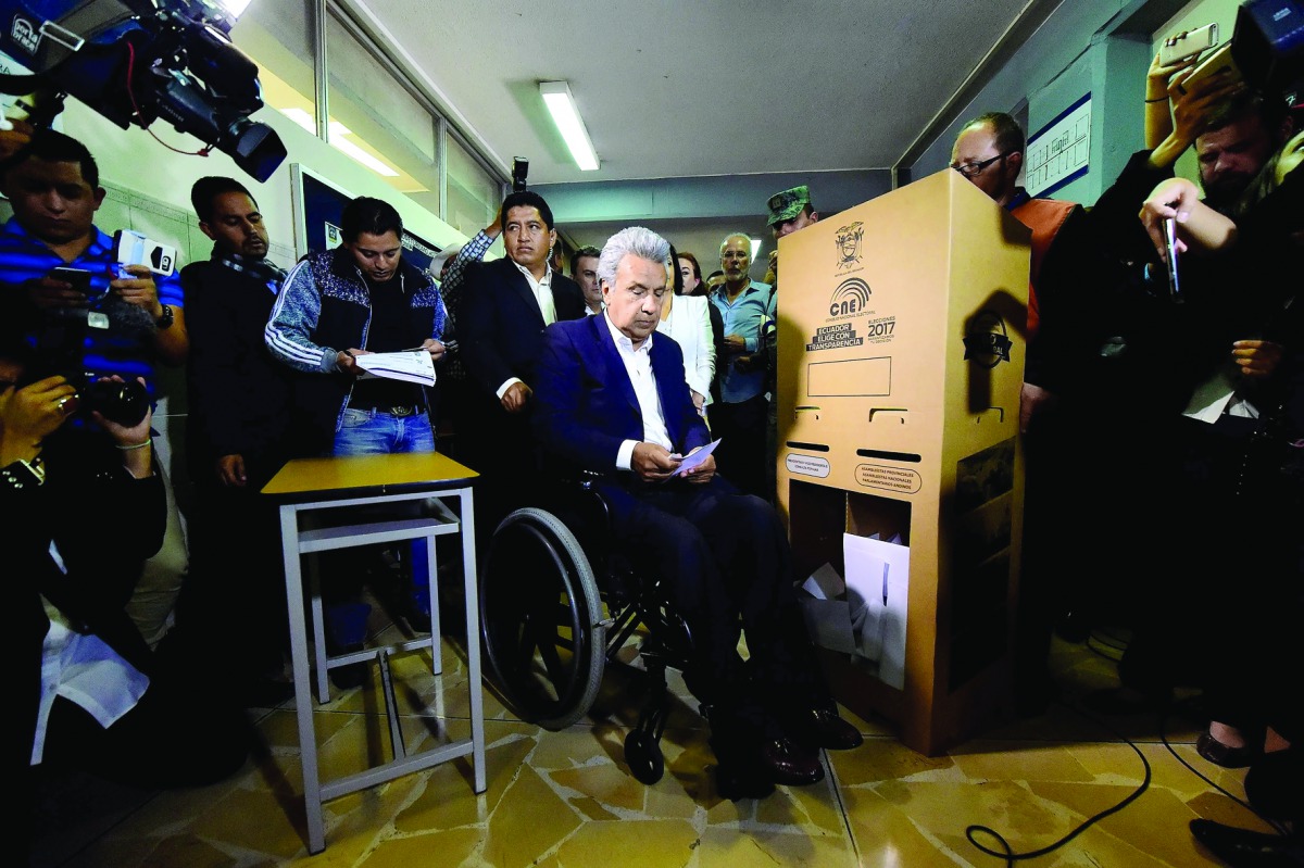 Ecuadorean presidential candidate of the Alianza PAIS party, Lenin Moreno (centre), votes at a polling station in Quito, yesterday.