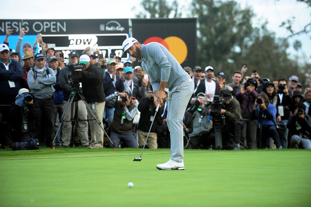 February 19, 2017; Pacific Palisades, CA, USA; Dustin Johnson putts on the eighteenth hole green during the final round of the Genesis Open golf tournament at Riviera Country Club. Gary A. Vasquez-USA TODAY Sports