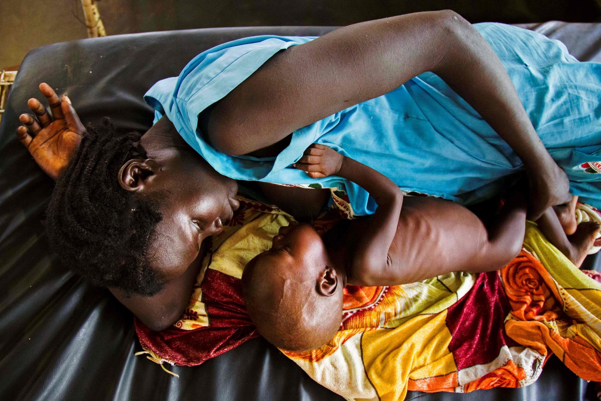 This file photo taken on October 11, 2016 shows a mother breastfeeding her child who suffers acute malnutrition at the clinic run by Doctors Without Borders (MSF) in Aweil, northern Bahr al-Ghazal, South Sudan. South Sudan's government said on February 20