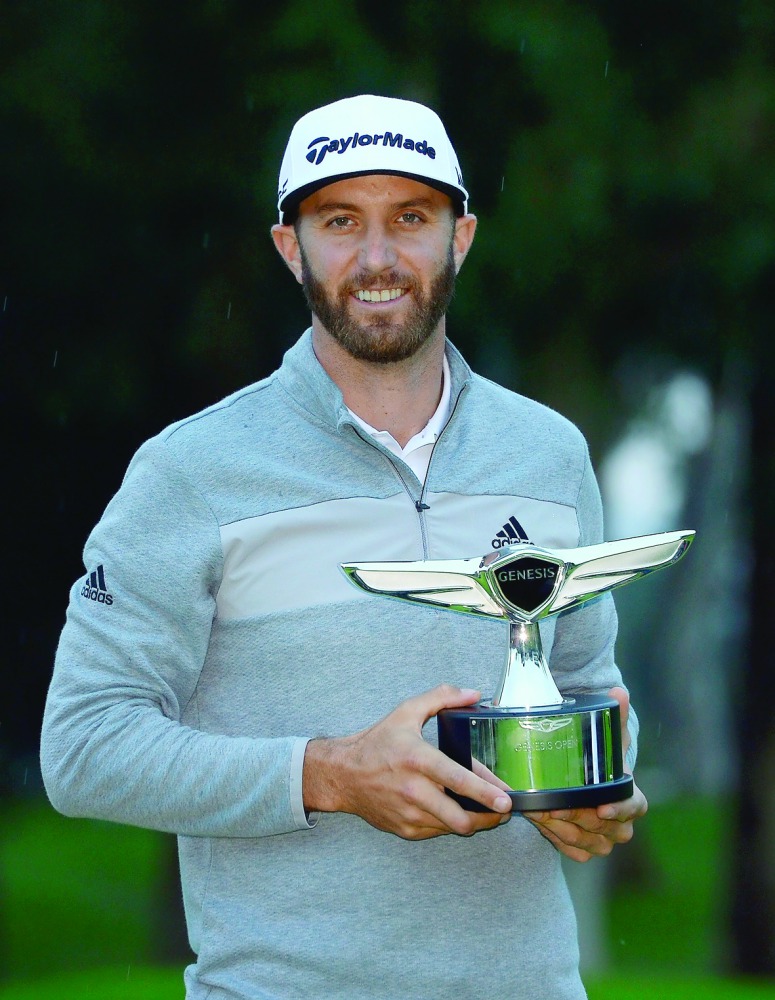 Dustin Johnson poses with the Genesis Open trophy in Pacific Palisades, California on Sunday.