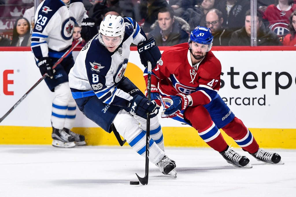 Jacob Trouba #8 of the Winnipeg Jets skates the puck against Alexander Radulov #47 of the Montreal Canadiens during the NHL game at the Bell Centre on February 18, 2017 in Montreal, Quebec, Canada. Minas Panagiotakis/AFP