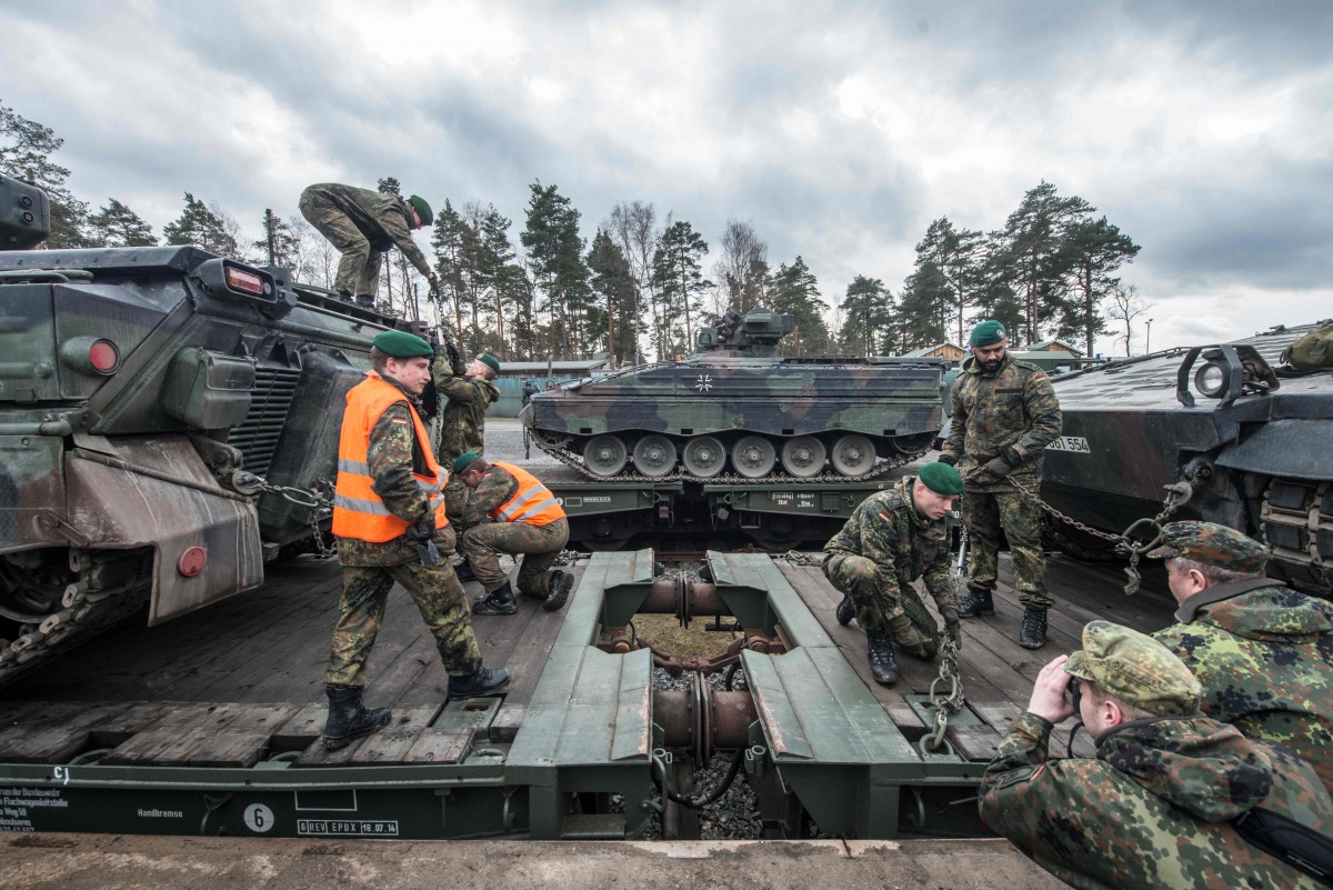 German soldiers load armored vehicles of the type 