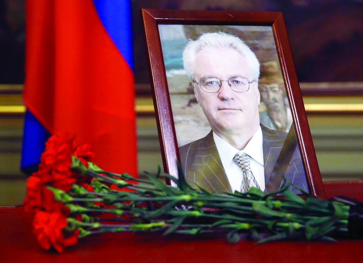 Flowers are laid in front of a portrait of Russia's Ambassador to the United Nations Vitaly Churkin at the Foreign Ministry guest house in Moscow yesterday. 