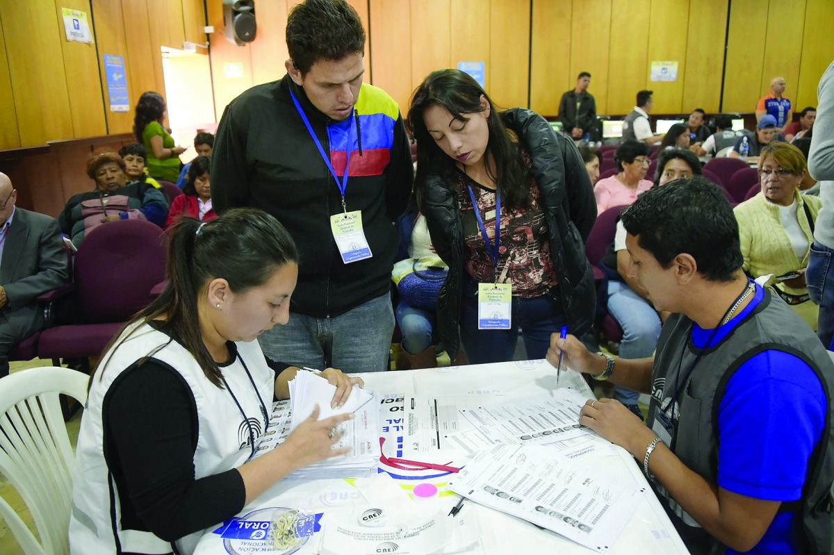 Members of the National Electoral Council count votes in Quito yesterday. 