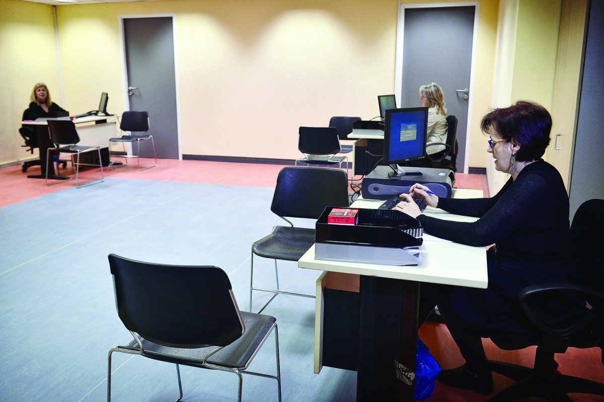 Employees working yesterday, during a presentation of the first government-run office to inform and facilitate the managing of banking debts in an Athens western suburb. The office, due to open for public next week is the first of 120 offices around Greec