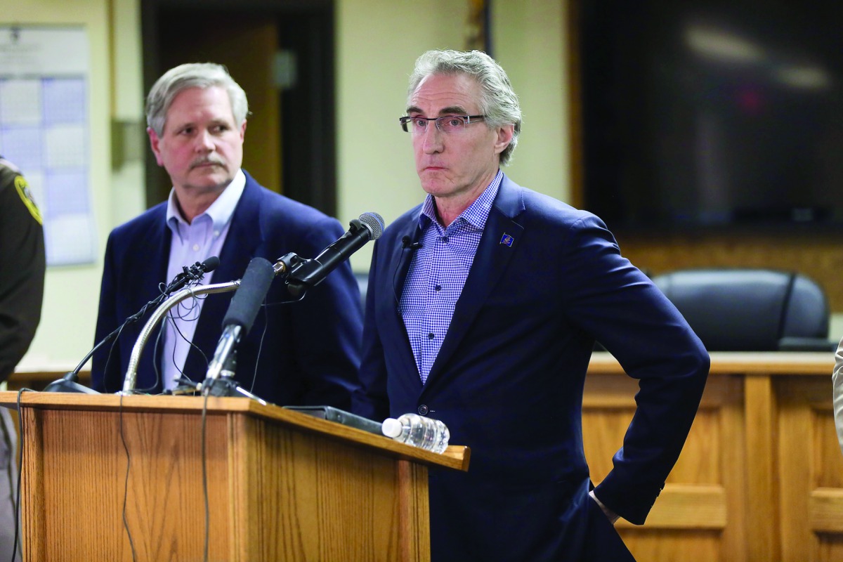 North Dakota Governor Doug Burgum (right) addresses a press conference announcing plans for clean up of Oceti Sakowin protest camp in Mandan, yesterday.